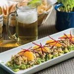 Photo.- page 76 | Francisco Estrada – Caption: Dos Mares puts its own spin on ceviche with a version that includes oranges, basil, marinated beets, and a guajillo vinagrette served on a bed of avocado.