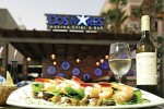 LCM 37      Photo:  - page 79 | Gilda Badillo.     Caption:This signature dish at Dos Mares Marina Grill & Bar     features shrimp broiled with white wine sauce and poached pears     with ginger atop a bed of spinach, mushrooms, Italian zucchini, and     Parmesan cheese.
