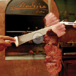 Photo.- page 88 | Miguel Ventura – Caption: The Brazilian-style rodízio at Madeira Bistro is brought to your table and sliced right there by your server