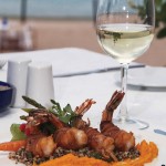 Photo.- page 72 | Miguel Ventura – Caption: Enjoy a romantic dinner of baccon-wrapped shrimp at Baja Cantina Beach.