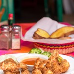 Photo.- page 78 | Hugo Róman – Caption: the coconut shrimp at El Coral is a favorite
