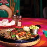 Photo.- page 80 | Hugo Román - Caption: It's a feast of fajitas at El Coral in downtown Cabo San Lucas.