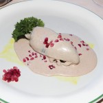 Photo.- page 86 | Miguel Ventura – Caption:  the chile en nogada at Los Deseos features a chile stuffed with beef and pork then topped with nuts and a cold almond sauce