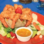 Photo.- page 76 | Miguel Ventura – Caption: The coconut shrimp at Campestre Restaurant Bar comes served with mixed greens and fresh fruit.
