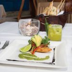 Photo.- page 82 | Miguel Ventura – Caption:La Panga Antigua serves market-fresh entrées like this tlacoyo topped with smoked fish, cilantro, avocado, and red onion and served with a green tomato and chile sauce.
