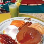 Photo.- page 66 | Carlos Aboyo – Caption: A Médano Beach favorite, Mango Deck is home to an excellent Sunday buffet and the famous Two, Two, Two, Two breakfast.