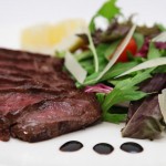 Photo.- page 69 | Arlen Rodriguez – Caption: The Tagliata di Manzo features a juicy rump steak that's served with a spring mixed salad, shaved Parmesan, and cherry tomatoes.