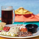 Photo: - page 84| Carlos Aboyo – Caption: The Mexican combo platter at Mango Deck includes arrachera, chicken enchilada, chile relleno, rice, and beans.