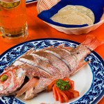  Whole Red Snapper.- seasoned and served with rice, salad, butter pepper and lime