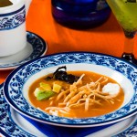 Tortilla Soup.- crispy fried strips of corn in a tomato-based chicken stock dried chiles, avocado, cheese, sour cream and lime.