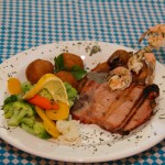 Signature Black Forest Schnitzel: smoked pork chop with skewered shrimp, choice between pork or chicken schnitzel, served with steamed vegetables with hollandaise sauce and pomme croquettes (mashed potatoes lightly breaded and fried).