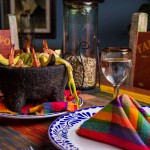 LAVA STONE MOLCAJETE.- Delicious baked & grill dish served with Nopal scallions, panela cheese, avocado and chicken