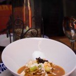 TORTILLA SOUP.- Corn and guajillo based with panela cheese avocado and fine crispy tortilla strips
