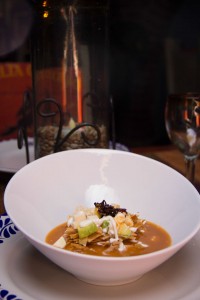 TORTILLA SOUP.- Corn and guajillo based with panela cheese avocado and fine crispy tortilla strips