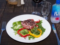 Seared Tuna Medallion.- with black sesame crust, arugula salad and balsamic vinegar reduction