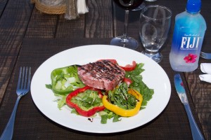 Seared Tuna Medallion.- with black sesame crust, arugula salad and balsamic vinegar reduction