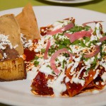Red or Green Chilaquiles, accompanied by roasted tomatillo, fried plantain and refried beans