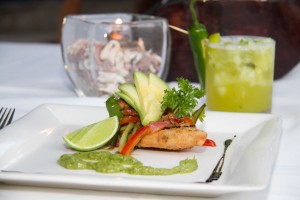 Tlacoyo Filled with Requesón and topped with home made smoked fish, cilantro, avocado, red onion and green tomato and chilli pepper sauce.