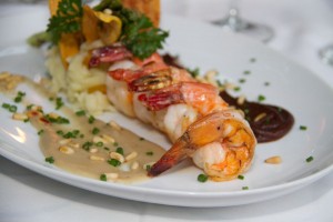 Jumbo Shrimps Duo of Moles.- white & black mole served with plantain purée & baby vegetables.