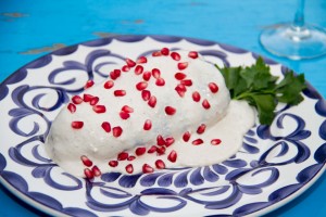 Chile en Nogada.- A specialty dish to celebrate Independence Day. Roasted and peeled Poblano pepper stuffed with sautéed meats, seeds and dried fruit, served with afresh cold walnut & sherry cream sauce. One of Mexico's finest.