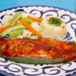 Pescado TikinXic.- Basted in achiote (ground annatto seeds, spices, tomatoes) & grilled in a banana leaf.