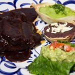 Costilla de Puerco en salsa de tamarindo.- Oven roasted sholder spare rib, smothered in a delicious smokey chile & tamarindo adobo. A great sweet & sour flavor. Served with fresh cilantro mashed potatoe, beans & guacamole