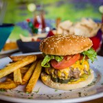 Cheese burger with hand-cut fries potatoes.