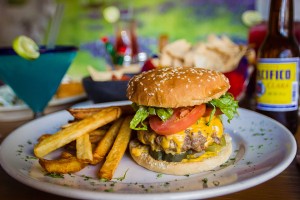 Cheese burger with hand-cut fries potatoes.