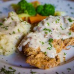Chicken fried steak with garlic -chive mashed potatoes and cream gravy.