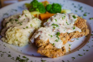 Chicken fried steak with garlic -chive mashed potatoes and cream gravy.