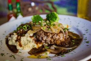 Hamburger steak with grilled onions, garlic chive mashed, potatoes and brown gravy.