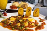 Motuleños Eggs – two eggs over easy, refried beans & ham on a corn tortilla covered with ranchero sauce peas and cheese. Topped with fried banana