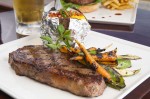 Photo: - page 72 | Francisco Estrada • Caption: Enjoy a hearty steak dinner with a baked potato and vegetables at Baja Cantina Beach.
