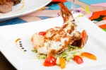"At Don Sanchez, the lobster tail is baked with Parmesan, then served with fennel, cherry tomatoes, and squid ink pancetta risotto." – Published in LCM 36 Page 7