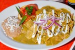 Chilaquiles Verdes – Soft chips with green sauce with chicken, served with beans, sour cream and cheese