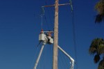 Two CFE teams work on repairing lines on Highway 1 near Soriana Plaza, Cabo San Lucas